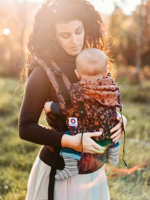 Back view of the Sapphire Yoga Baby Carrier in use during golden hour, highlighting its handcrafted cashmere detailing and snug support.