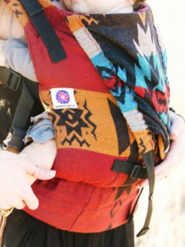 Close-up of the Almitra Tattva Yoga Carrier showing rich woven Kullu fabric, secure buckle system, and supportive structure for safe babywearing.