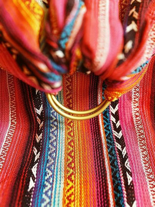Close-up of the Larona Ring Sling showing vibrant rainbow woven patterns and sturdy gold safety-tested ring – Almitra Tattva Bohemian Collection.
