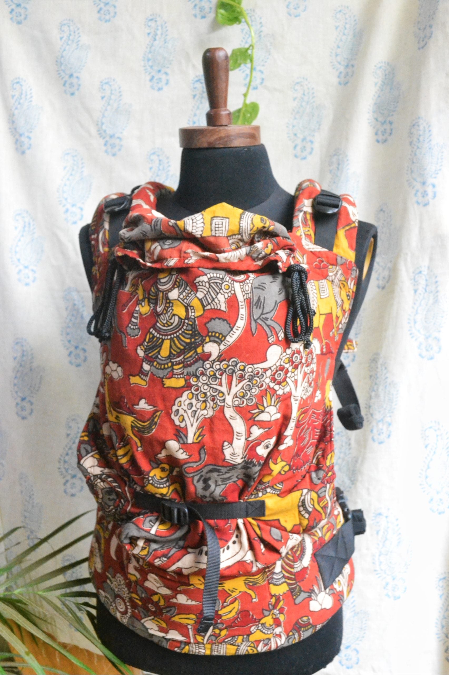Jataka Tales Baby Carrier ergonomic carrier in red Kalamkari cotton , soft structured carrier with padded straps and waist support, breathable babywearing design for hands-free parenting and everyday movement.