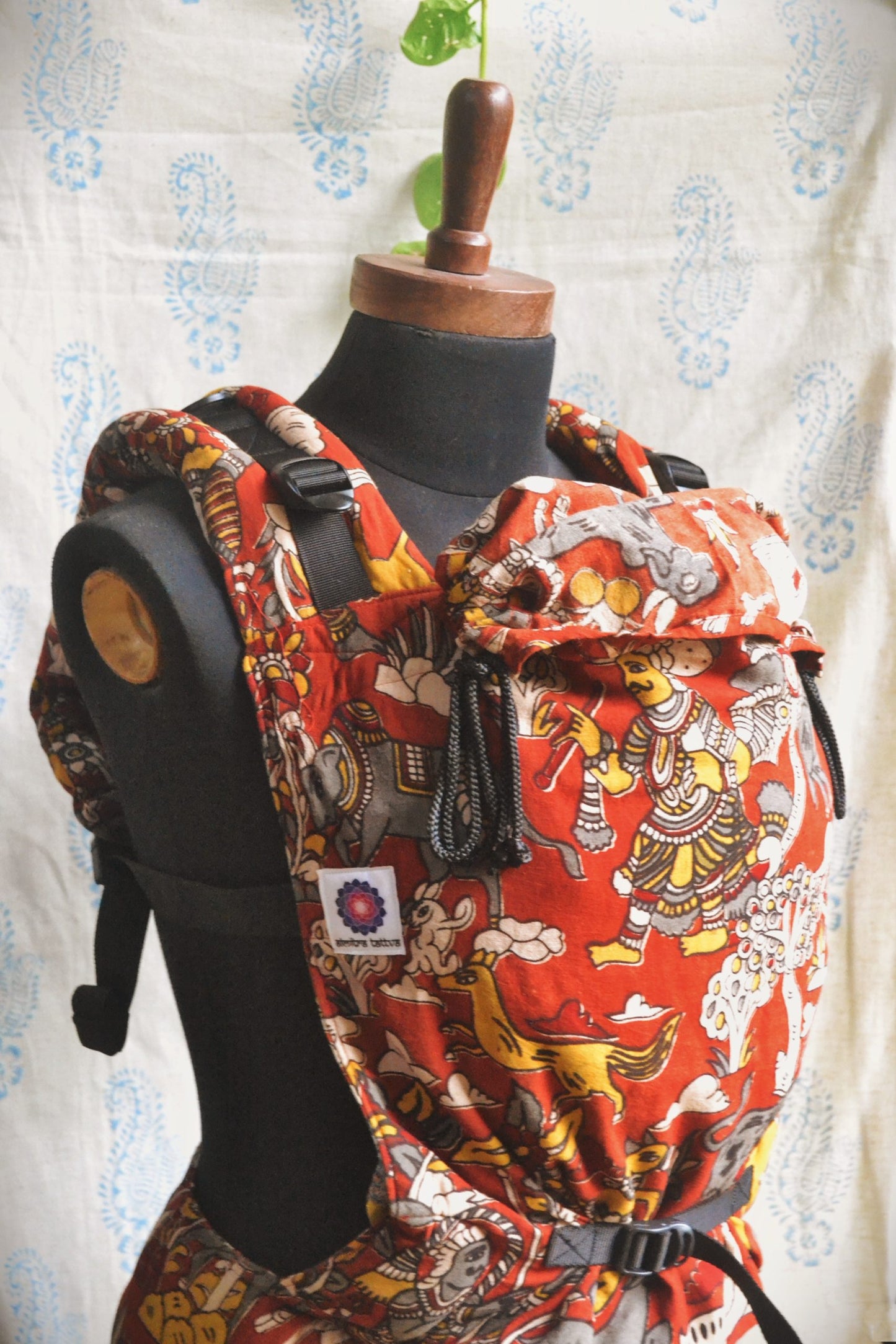 Jataka Tales baby carrier, featuring adjustable shoulder straps, cushioned waistband, and Kalamkari cotton fabric, ergonomic baby carrier designed for newborn to toddler carry and balanced weight distribution.