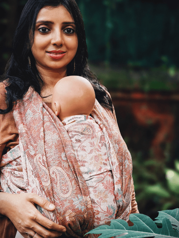 Close-up of Jhelum Baby Wrap Carrier with a secure front carry fit. Breathable woven fabric contours around baby and caregiver, offering ergonomic support, skin-to-skin closeness, and everyday hands-free movement.