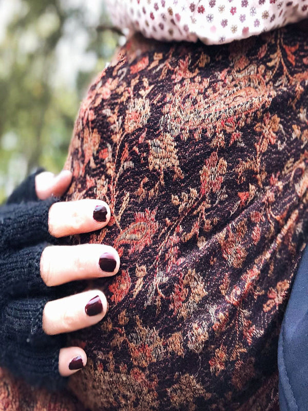 Close-up of Almitra Tattva Kalindi Ring Sling in rich Jamawar pattern, showcasing the intricate paisley and floral design in earthy rust and black tones.