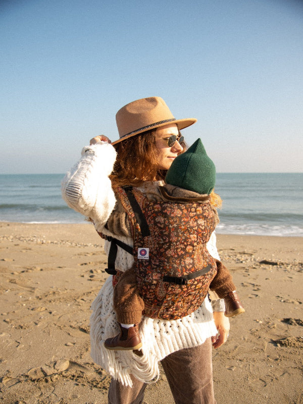 Kalindi Yoga Baby Carrier ergonomic, front carry position in floral paisley wool cashmere fabric, adjustable straps for secure fit, newborn-to-toddler carrier built for hands-free parenting and conscious outdoor living.