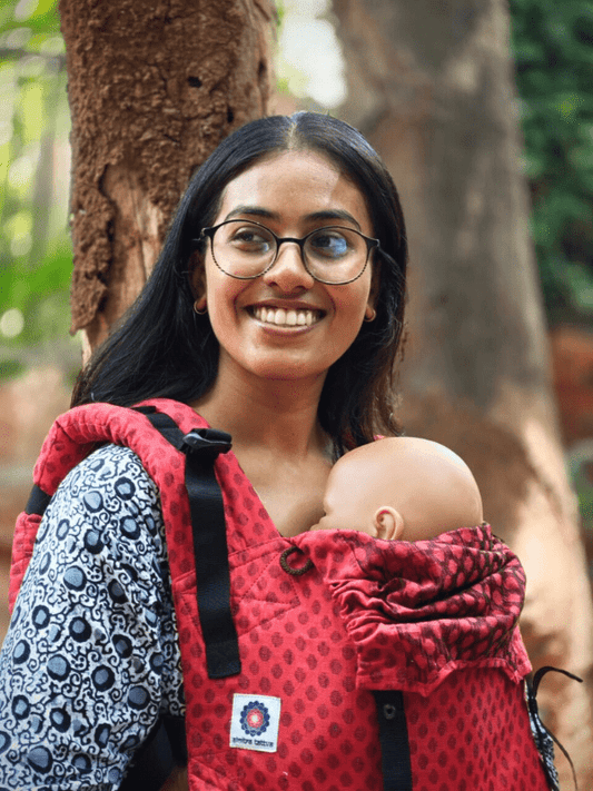 Mangalmay Sunrise soft structured baby carrier outdoors, featuring cotton fabric, padded shoulder straps, and ergonomic front carry for newborn, supporting breathable comfort, secure fit, and inclusive hands-free parenting in nature.