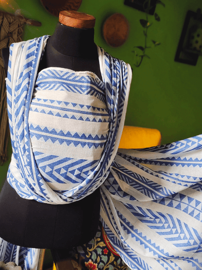 Almitra Tattva Neelanjana woven wrap displayed on mannequin, showing geometric tribal patterns in blue and white cotton blend fabric.