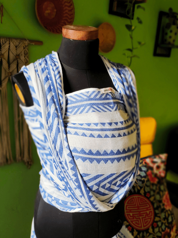 Neelanjana ergonomic baby wrap  in blue and white woven cotton, featuring structured chest panel, wide shoulder spreads, and wrap-style support for newborns and toddlers, crafted for breathable comfort and gender-neutral babywearing.