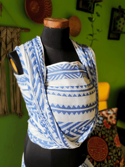 Neelanjana ergonomic baby wrap  in blue and white woven cotton, featuring structured chest panel, wide shoulder spreads, and wrap-style support for newborns and toddlers, crafted for breathable comfort and gender-neutral babywearing.