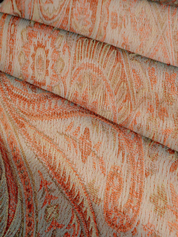 Angled view of the Tushara ergonomic baby wrap folded in layers, highlighting its structured yet soft weave in earthy ivory and ember tones, suitable for newborn baby carriers, wrap slings, and long-wear comfort for all caregivers.