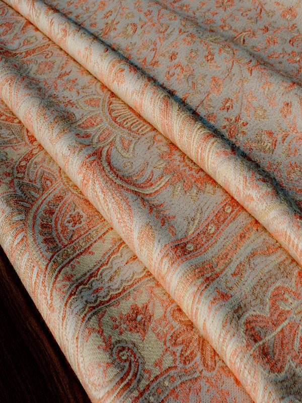 Detailed macro view of the Tushara raw weave newborn wrap showing layered folds of breathable handwoven fabric in ivory and ember hues, emphasizing texture, strength, and comfort for ergonomic newborn baby carrying and everyday wrap sling use.