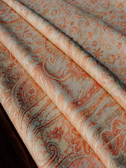 Detailed macro view of the Tushara raw weave newborn wrap showing layered folds of breathable handwoven fabric in ivory and ember hues, emphasizing texture, strength, and comfort for ergonomic newborn baby carrying and everyday wrap sling use.