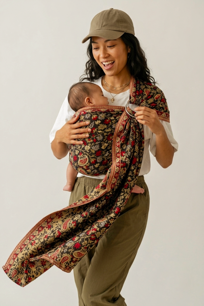 Close-up of a mother nuzzling her head against her baby, who is held securely in the Chenab 2.0 Cashmere Collection ring sling.